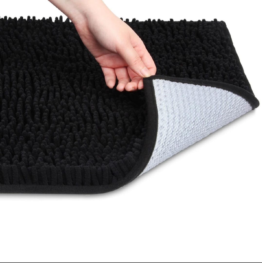 Black textured mat with a hand holding it, showing the soft side.