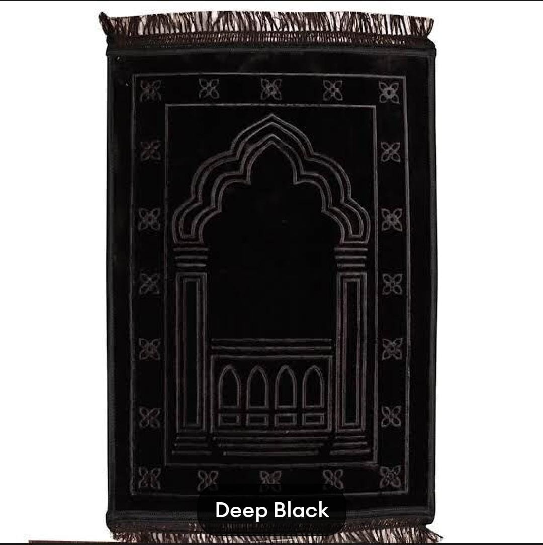 Black prayer mat with decorative arch design on a white background