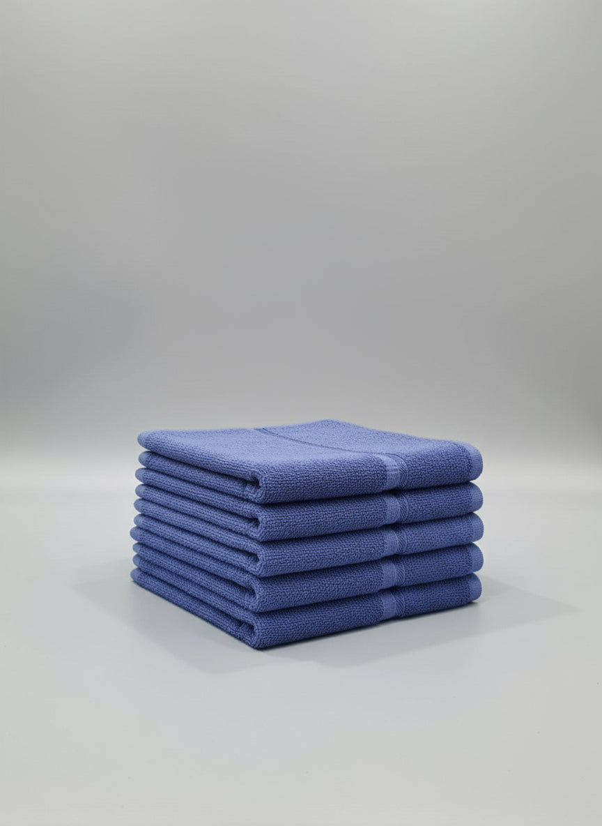 Blue towel on a cardboard box with a tiled floor background