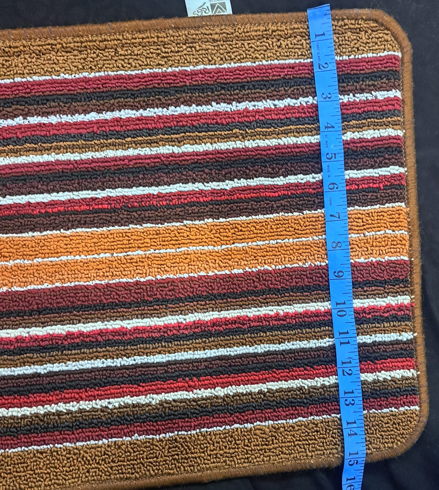 Striped fabric with a measuring tape on a dark background