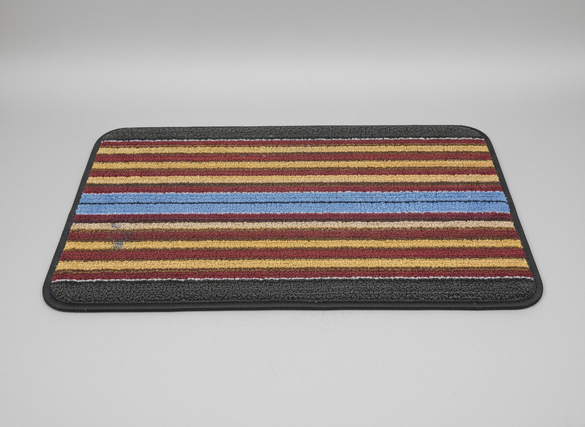 Striped rug with red, yellow, and blue stripes on a dark background