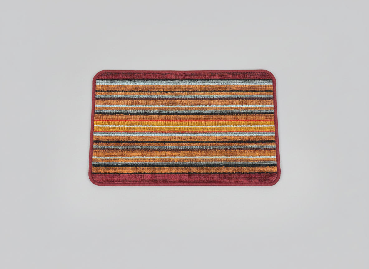 Multicolored striped rug with a red border on a black background