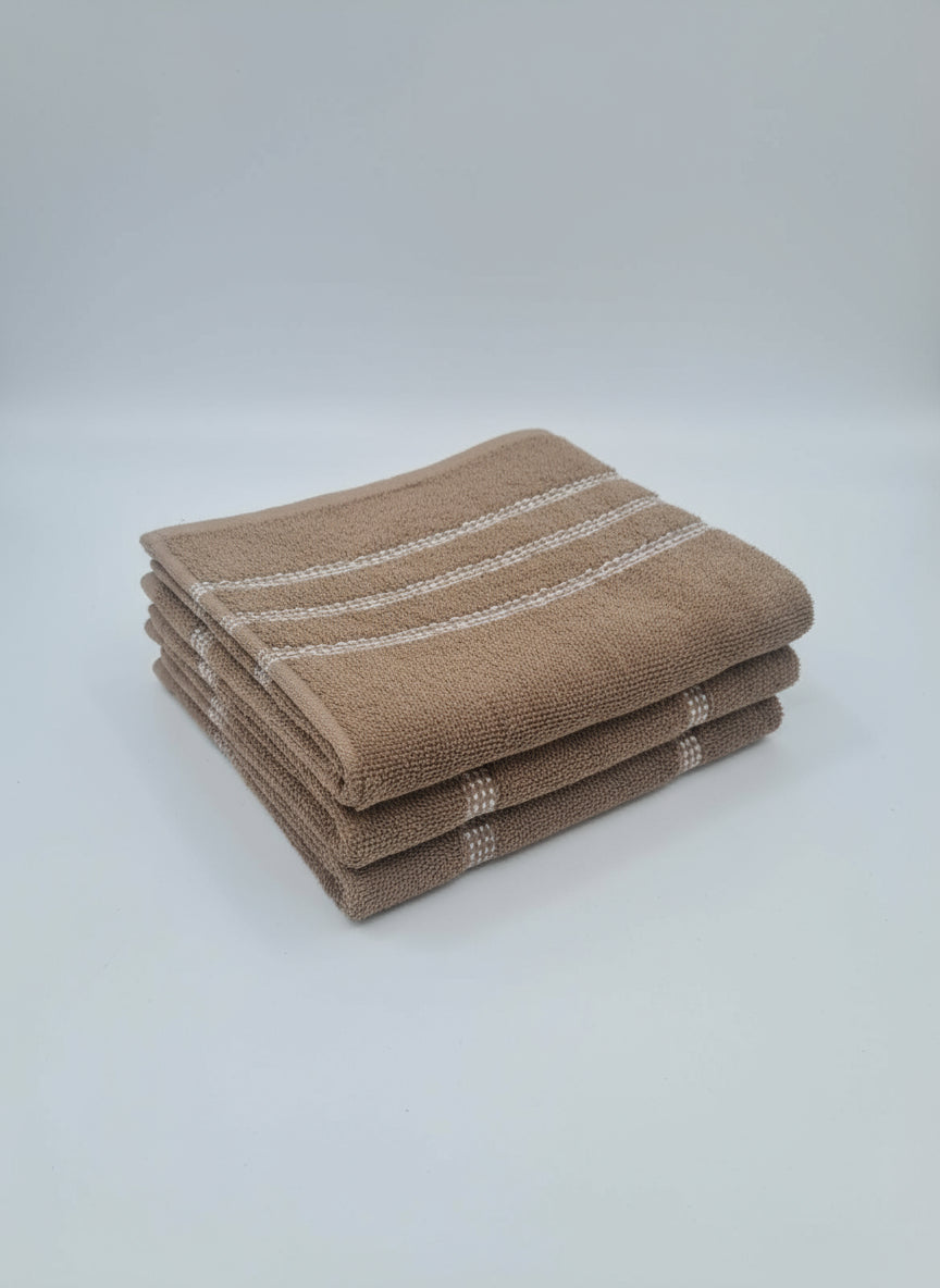 Brown towel with white stripes on a cardboard box