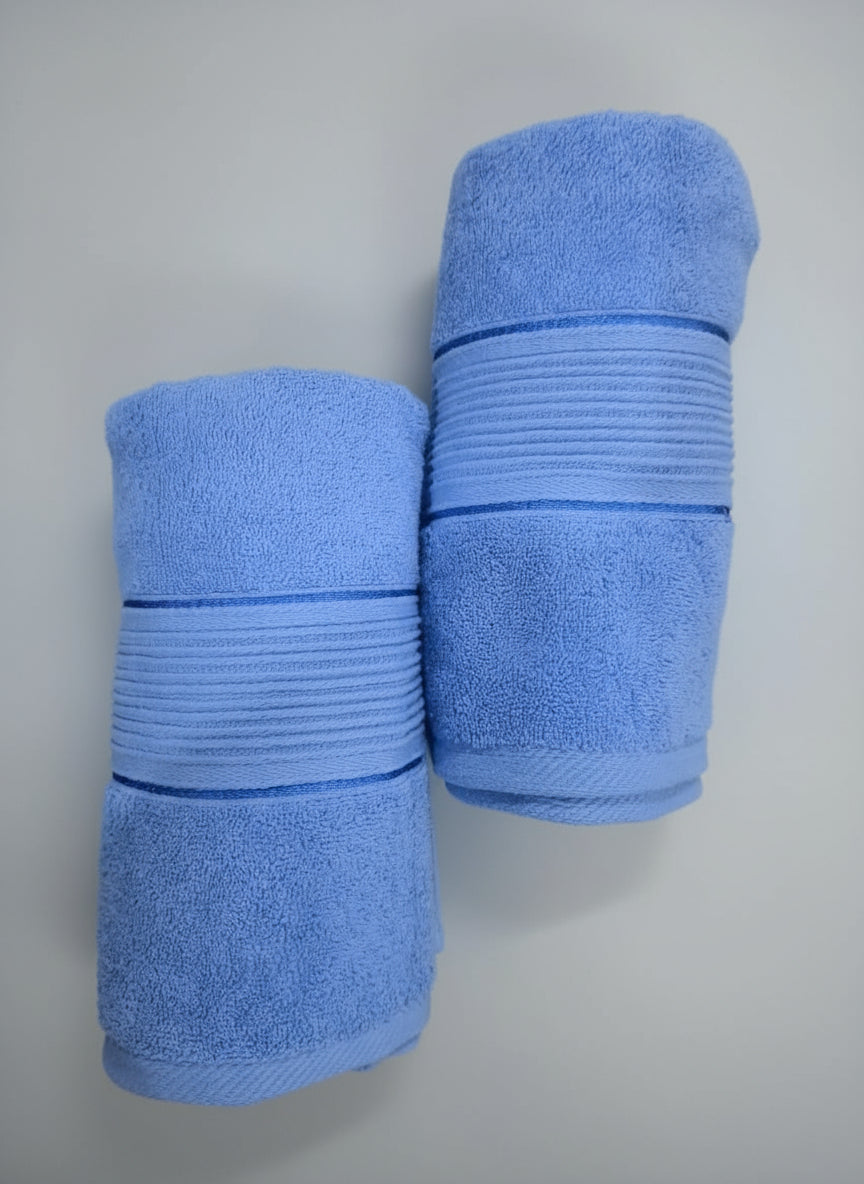 Two blue towels stacked on a black background