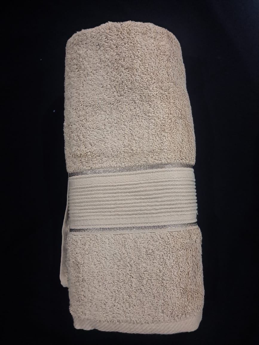 Folded beige towel on a black background