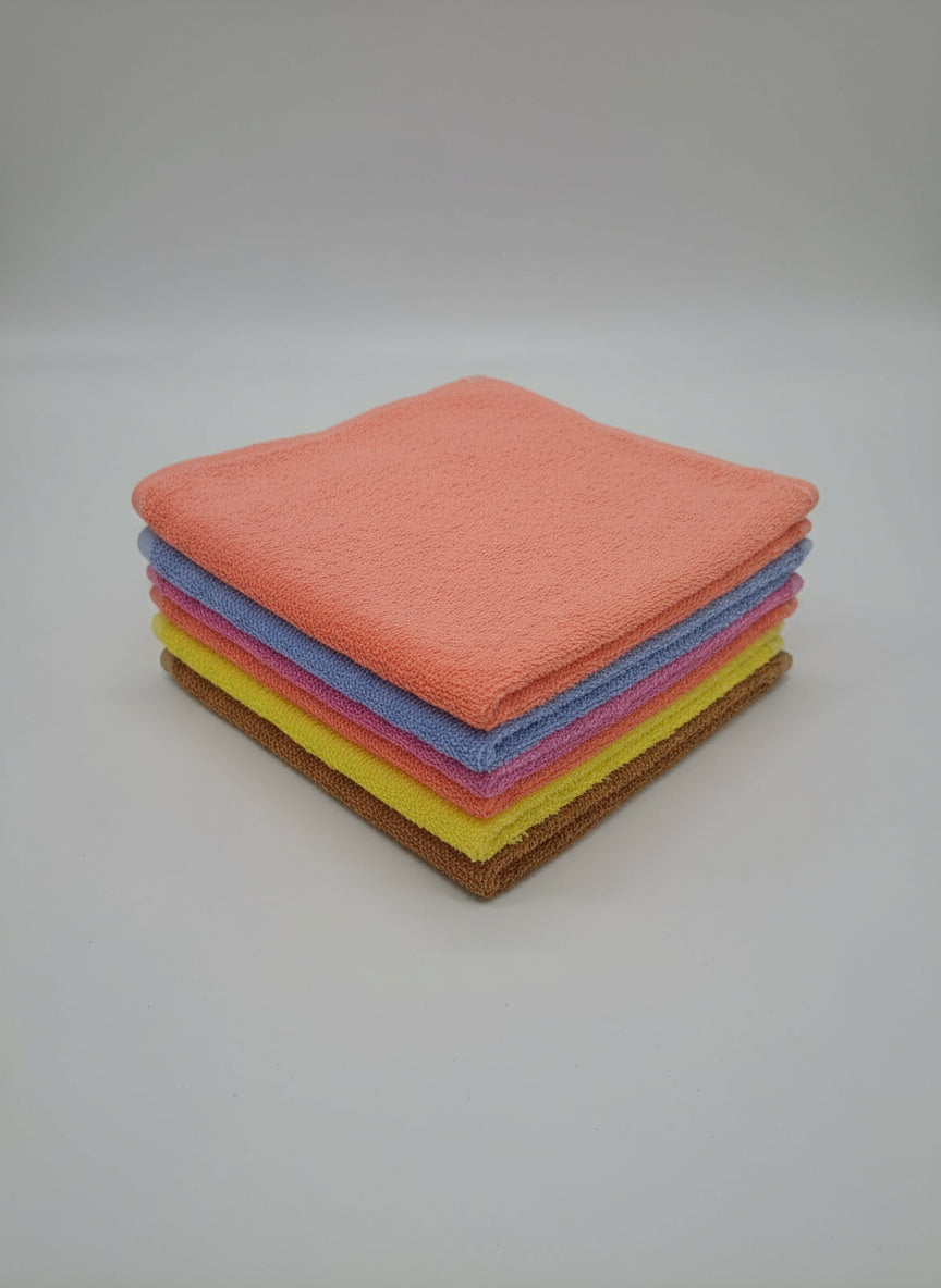 Set of colorful microfiber cloths on a white floor.