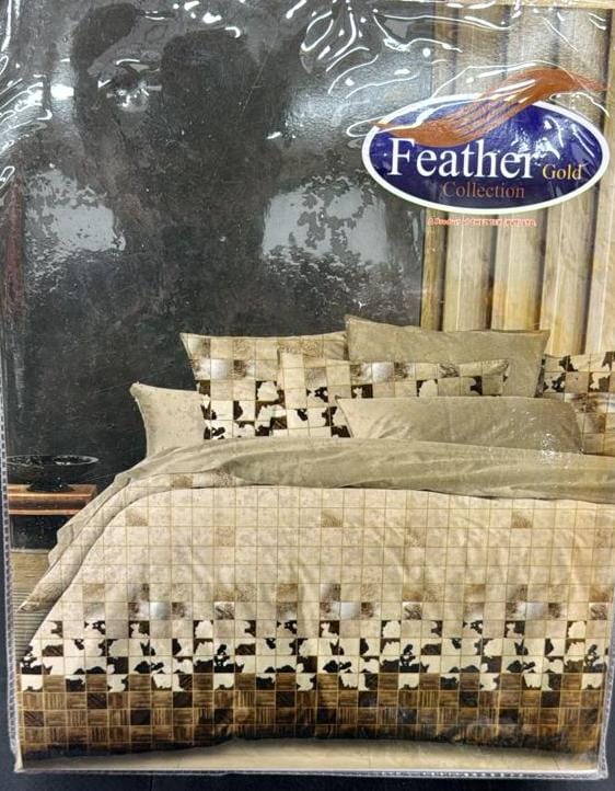 Bedding set packaging with 'Feather Gold' logo on a reflective surface