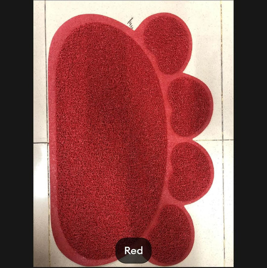 Red foot-shaped rug on a tiled floor
