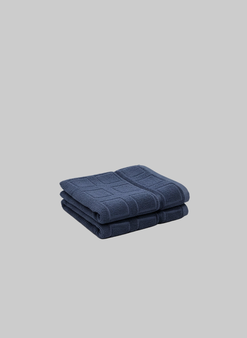 Folded blue towel on a gray background