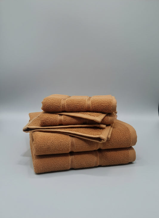 Brown towel on a cardboard box with a white floor background