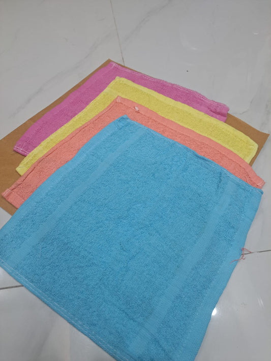 Set of colorful microfiber cloths on a white tiled floor
