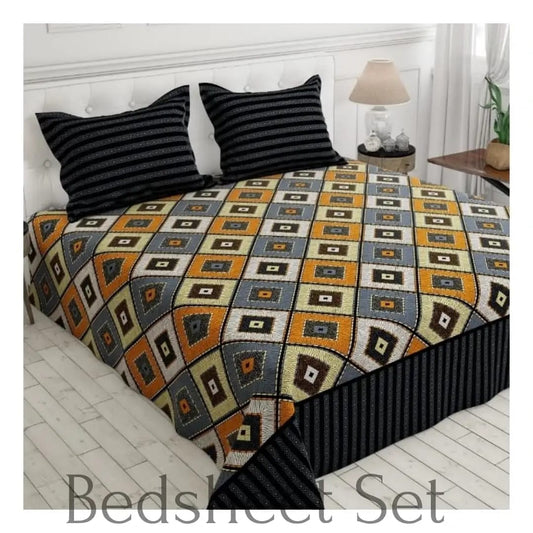 Geometric patterned bedspread on a bed with striped pillows in a bedroom setting.